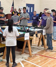 Elgin Eagle Robotics Team around competition table