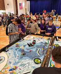 Robotics team looking over competition table